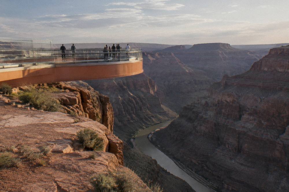 A glass-bottomed bridge extending over a deep canyon at Grand Canyon West
